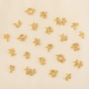 Detailed shot of 18k gold plated alphabet charms with cubic zirconia for DIY jewelry
