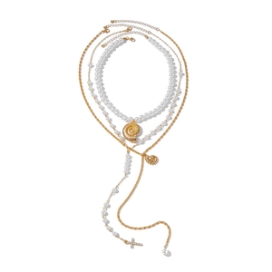 Bohemian multi-layer gold necklace with faux pearls, shell pendants, and cross charm