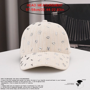 Detail of corduroy baseball cap with metal letters showing texture and 57-58cm head size