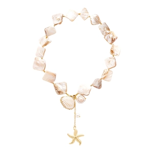 Elegant seaside necklace with shell pendant and golden starfish on polished shell beads