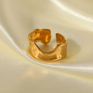 Irregular gold wave texture open ring in titanium steel on soft yellow silk background