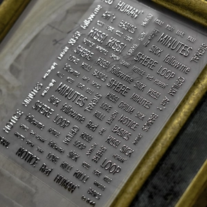 Detail shot of silver metallic laser nail art stickers with embossed English letters No 046