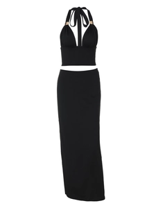 Detail of black halter top and slim maxi skirt set with silky elastic fabric texture