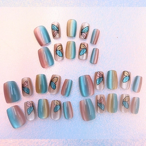 Cat-eye butterfly press-on nails with pink blue yellow gradient and artistic wing patterns