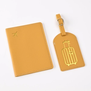 Detail of yellow PU leather passport cover and luggage tag set with gold foil stamping