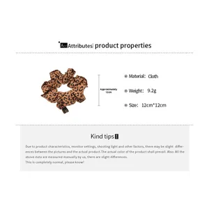 Detail showing cloth leopard print hair scrunchie with 12cm size and soft fabric texture