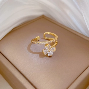 Macro shot of gold floral ring with crystals on satin background for luxury gift