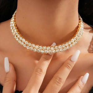 Close-up of a luxury gold double-layer tennis necklace with round-cut sparkling crystals