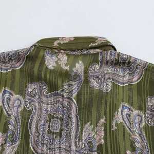 Close-up of olive green paisley print shirt with gold metallic pinstripe detailing