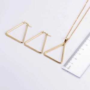 Size comparison of gold triangle jewelry set with earrings and necklace on white background