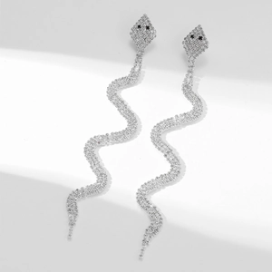 Elegant silver snake tassel earrings with white rhinestones and black eyes on white background