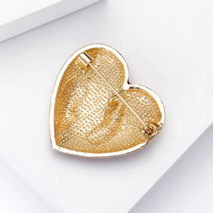 Golden enamel heart brooch back view with durable pin closure and 18K metal texture