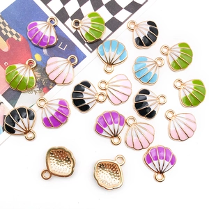 Macro detail of colorful enamel shell pendants for DIY jewelry with gold metallic finish