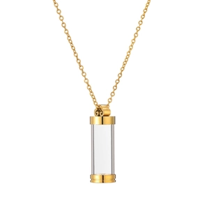 Macro detail of a gold refillable cylinder perfume pendant necklace with scrollwork design