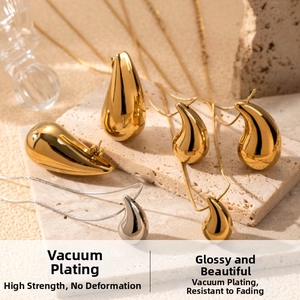 Macro detail of hammered waterdrop jewelry set with polished gold and silver finishes