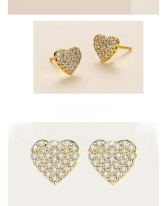 Close-up of gold heart stud earrings with micro-pave cubic zirconia crystals