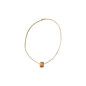 Gold plated cylinder necklace featuring red and white zircon crystals on white background