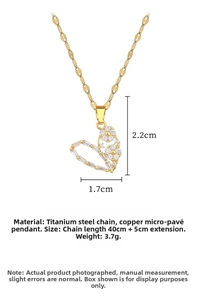 Detailed view of heart-shaped pendant with floral cubic zirconia insets on gold chain