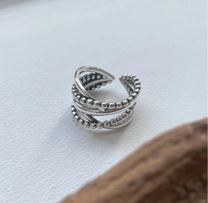 Macro shot of 925 sterling silver multilayer beaded ring with adjustable open design