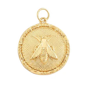 Macro view of a 29mm gold-tone insect relief coin pendant showing size and weight specs