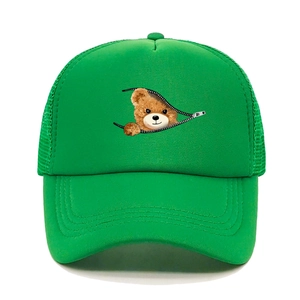 Detail of a bright green trucker hat featuring a zipper bear print and mesh back