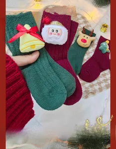 Detail of thick plush Christmas socks with 3D Santa, reindeer, and tree ornaments