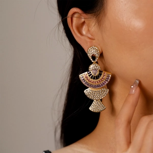 Detail of Art Deco fan-shaped earrings with colorful crystals and gold plating