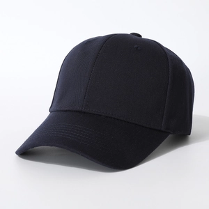 Detail view of a navy blue cotton baseball cap showing textured fabric and stitching