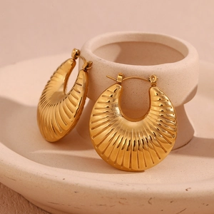 Macro shot of 18K gold plated hollow hoop earrings with vertical groove texture