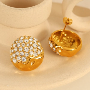 Elegant gold dome earrings with sparkling rhinestones on a minimalist ceramic background