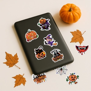 Close-up of laser Halloween stickers on electronic device with pumpkins and maple leaves
