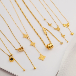 Selection of golden stainless steel necklaces with clover and butterfly pendants for women