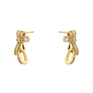 Elegant gold bow earrings with shimmering white zircon stones on a clean white background