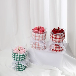 Three handmade soap rose bouquets in red, pink, and green with tweed packaging detail