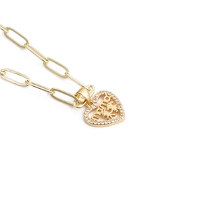 Detail of gold heart pendant with mama lettering and sparkling zircon stones for Mother's Day
