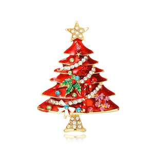 Detailed view of red enamel Christmas tree brooch with colorful rhinestones and gold bow