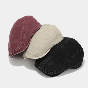 Vintage washed denim flat caps in burgundy, beige and black with classic stitching