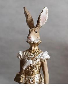 Detailed view of resin rabbit ornament featuring golden relief patterns and lace textures