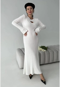 Detail of white knit dress featuring a heart-shaped cutout and elegant trumpet sleeves