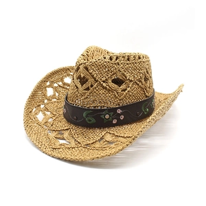 Detail of hollow woven cowboy hat with embroidered leather band and vintage rivets
