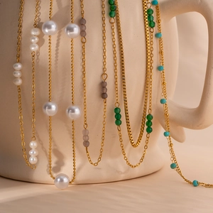 Detail of 18K gold plated stainless steel necklaces with pearls and colorful beads