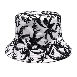 Close-up of cotton sun hat featuring black palm tree prints and reinforced brim stitching