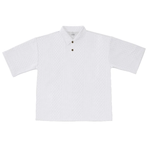 Detailed view of white men's polo shirt featuring geometric jacquard knit fabric and buttons