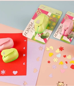 Detail showing colorful craft punches and paper cutouts in star bear and heart shapes