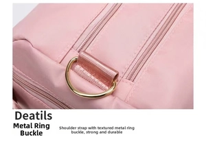 Detail of pink yoga bag featuring a reinforced gold metal D-ring and durable nylon fabric