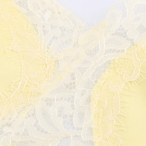 Detailed view of yellow eyelash lace fabric on a sexy backless camisole top