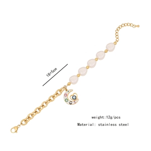 Detail of stainless steel bracelet with irregular pearls, evil eye pendant and size specs