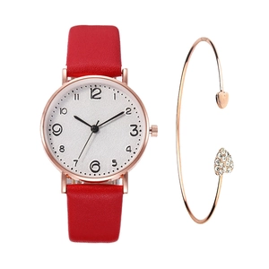 Detail of red leather watch paired with a rose gold heart bracelet on white background