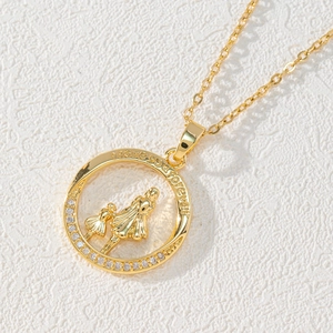 Detailed close-up of gold pendant with mother-daughter motif and white zircon stones