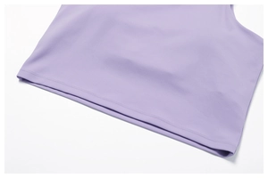 Macro shot of double-needle stitching on the hem of a purple high-elastic sports top